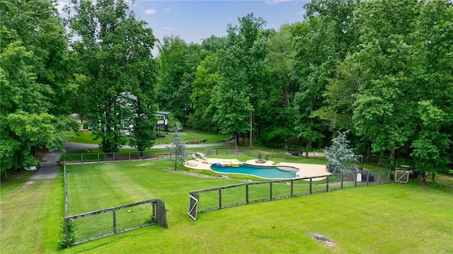 surrounding community featuring a swimming pool and a lawn