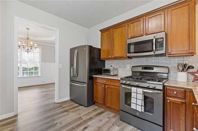 kitchen featuring brown cabinets and appliances with stainless steel finishes