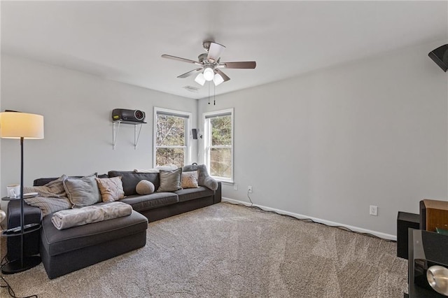 carpeted living area with visible vents, a ceiling fan, and baseboards