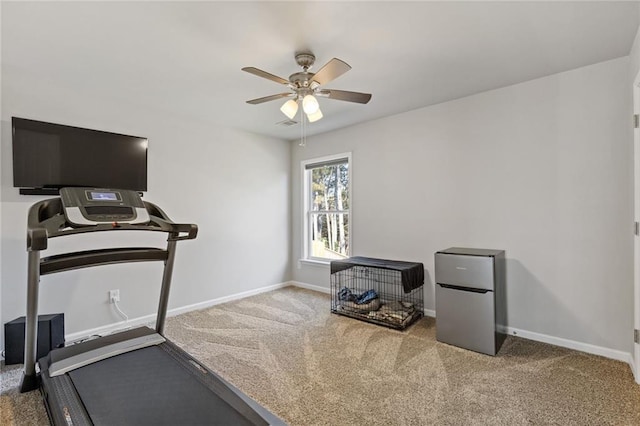 exercise room featuring baseboards, carpet floors, and ceiling fan