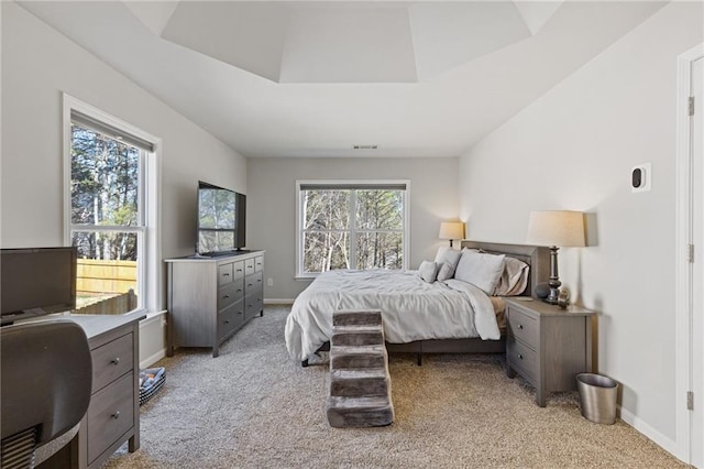 bedroom with visible vents, baseboards, and light carpet