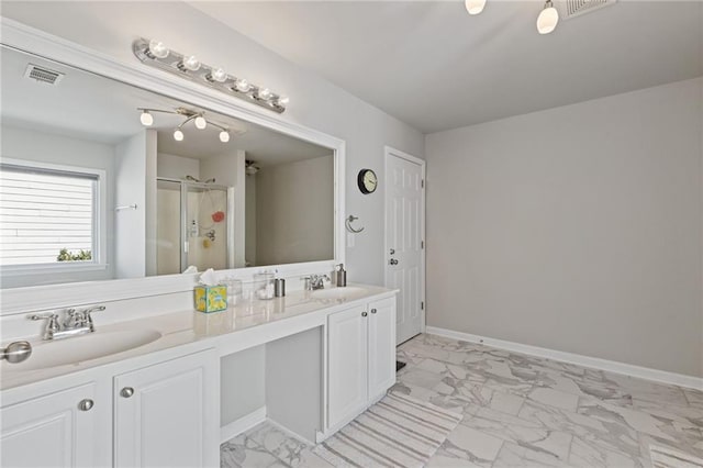 bathroom with visible vents, marble finish floor, a sink, a shower stall, and baseboards