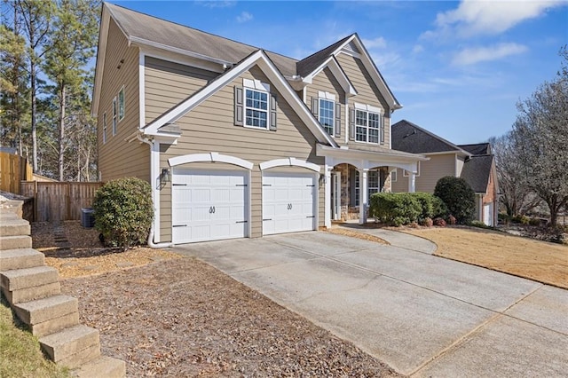 traditional-style house with central AC, concrete driveway, a garage, and fence