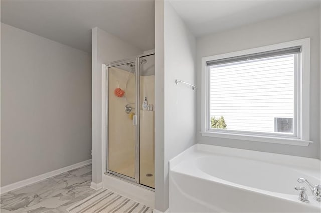 full bathroom featuring a bath, baseboards, a stall shower, and marble finish floor