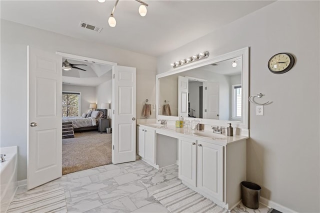 ensuite bathroom featuring ensuite bathroom, a healthy amount of sunlight, visible vents, and marble finish floor