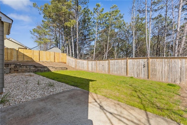 view of yard featuring a patio area and a fenced backyard