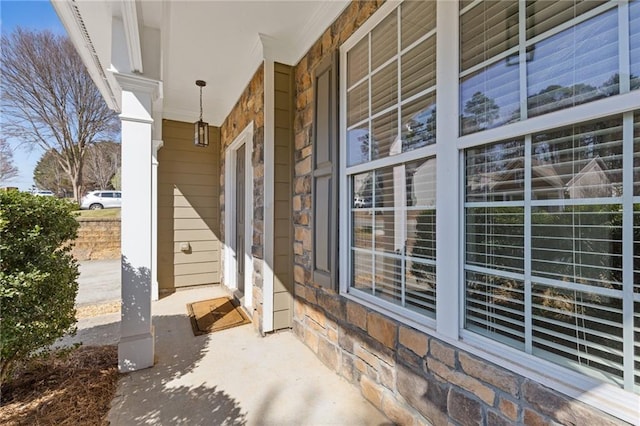 view of exterior entry featuring covered porch