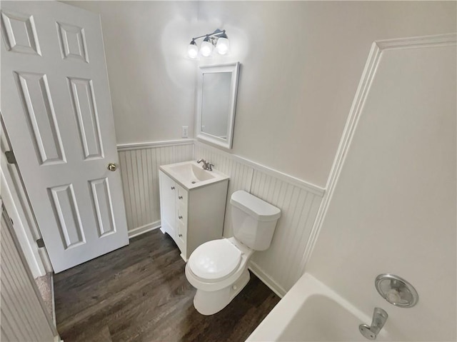 full bath featuring a wainscoted wall, vanity, toilet, and wood finished floors