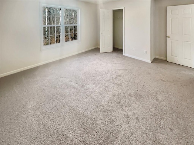 unfurnished bedroom featuring carpet floors, a closet, and baseboards