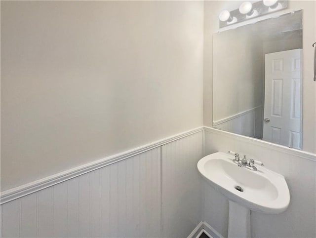 bathroom featuring wainscoting and a sink