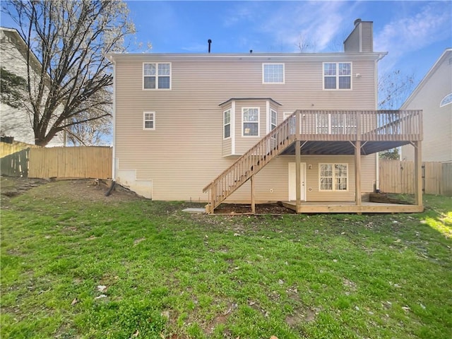 back of house featuring a yard, a chimney, fence private yard, and a wooden deck