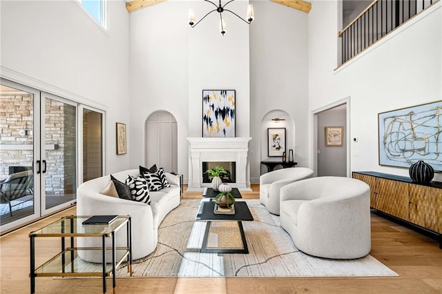 605 Claxton Ln, Milton, GA 30004 - living area with a high ceiling, wood finished floors, a chandelier, a fireplace with raised hearth, and arched walkways