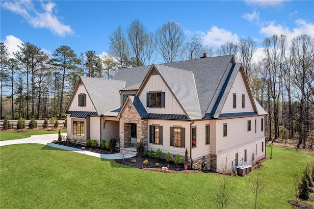 605 Claxton Ln, Milton, GA 30004 - modern farmhouse style home featuring a standing seam roof, a front yard, roof with shingles, board and batten siding, and a metal roof