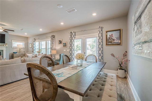 3715 Bridges Ct, Cumming, GA 30040 - dining space with light wood-style floors, a ceiling fan, baseboards, a fireplace, and recessed lighting