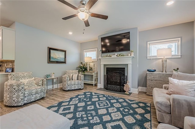 3715 Bridges Ct, Cumming, GA 30040 - living area with ceiling fan, healthy amount of natural light, a fireplace with flush hearth, baseboards, and recessed lighting