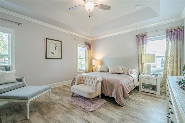 3715 Bridges Ct, Cumming, GA 30040 - bedroom featuring a raised ceiling, light wood-style flooring, baseboards, ceiling fan, and crown molding