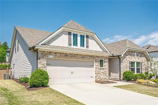 3715 Bridges Ct, Cumming, GA 30040 - craftsman inspired home featuring stone siding, board and batten siding, driveway, and a shingled roof