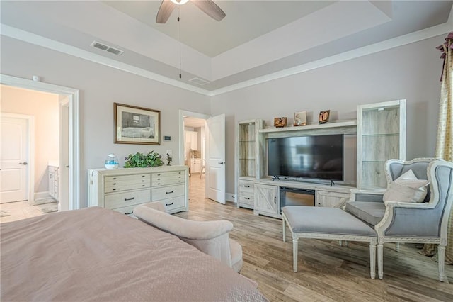 3715 Bridges Ct, Cumming, GA 30040 - bedroom with a raised ceiling, connected bathroom, light wood-style floors, a ceiling fan, and baseboards