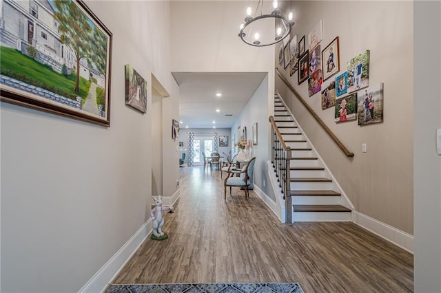 3715 Bridges Ct, Cumming, GA 30040 - foyer with stairway, wood finished floors, baseboards, and a chandelier