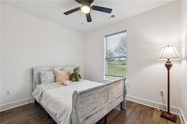 bedroom featuring visible vents, baseboards, and wood finished floors