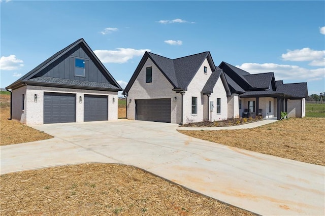 modern farmhouse style home featuring brick siding, board and batten siding, driveway, and a garage