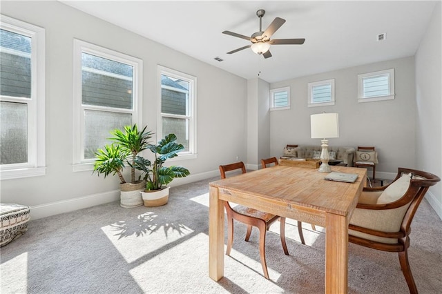carpeted dining area featuring ceiling fan