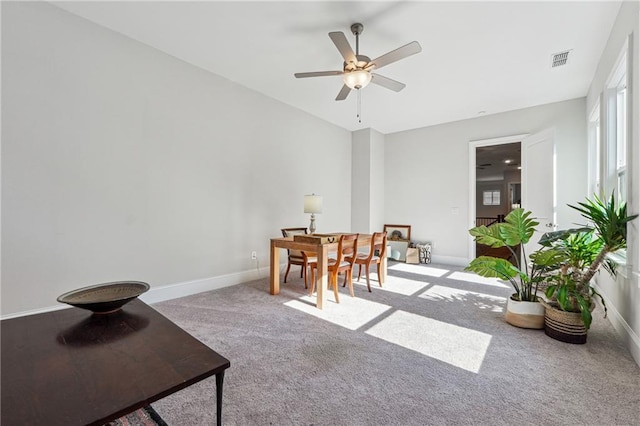 carpeted dining space featuring lofted ceiling and ceiling fan