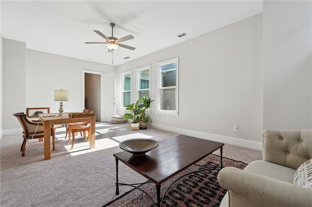 living room featuring carpet floors and ceiling fan