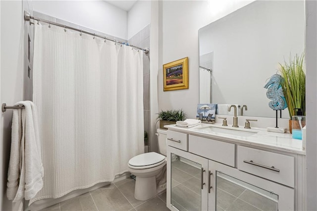 bathroom with tile patterned floors, toilet, and vanity