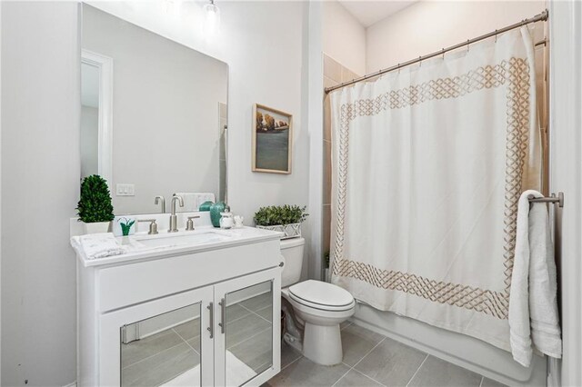 full bathroom with vanity, shower / tub combo, tile patterned flooring, and toilet