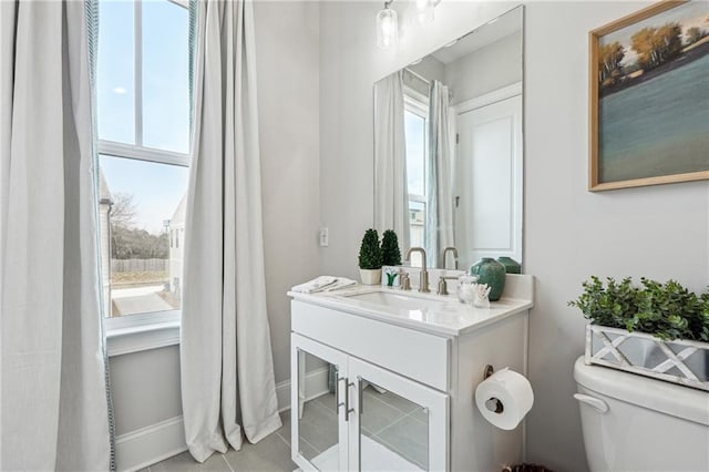 bathroom featuring tile patterned floors, toilet, and vanity