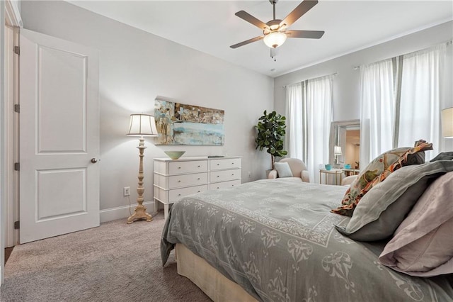 bedroom featuring light carpet and ceiling fan