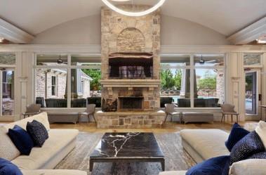 living room with lofted ceiling, a healthy amount of sunlight, and a fireplace
