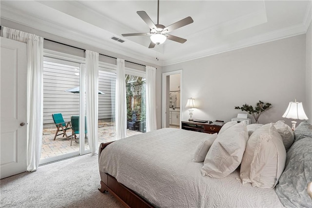 carpeted bedroom with ceiling fan, ornamental molding, access to exterior, and a raised ceiling