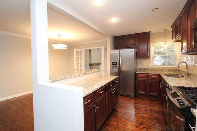 kitchen with light stone counters, dark wood-style flooring, a sink, ornamental molding, and appliances with stainless steel finishes