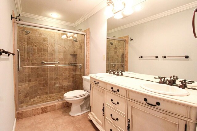 full bathroom with double vanity, ornamental molding, a stall shower, and a sink