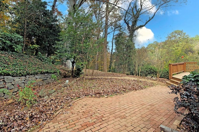 view of patio / terrace featuring a wooded view