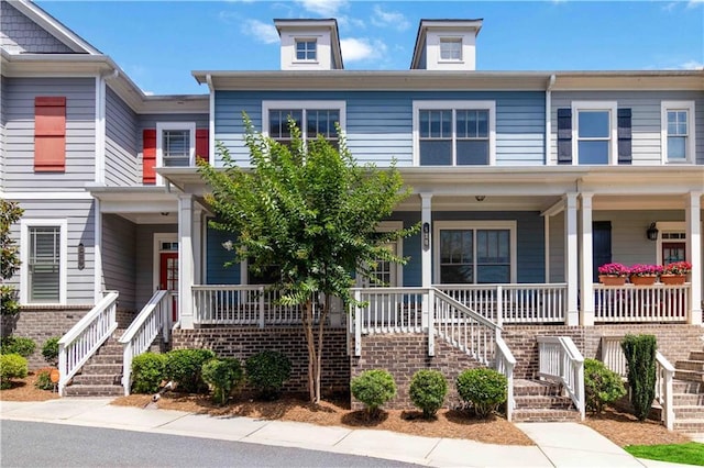 multi unit property featuring covered porch and stairway
