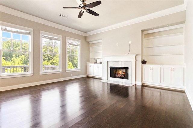 unfurnished living room featuring visible vents, built in features, a wealth of natural light, and dark wood finished floors