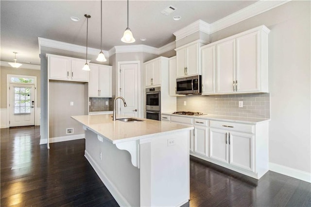 kitchen featuring white cabinetry, stainless steel appliances, dark wood-type flooring, and a sink