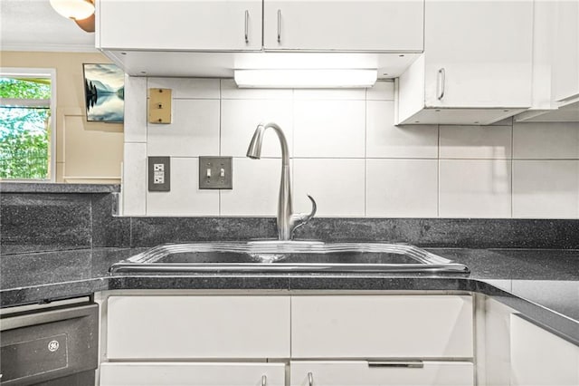 539 Mcgill Park Ave NE, Atlanta, GA 30312 - kitchen featuring a sink, white cabinets, decorative backsplash, ornamental molding, and dark countertops