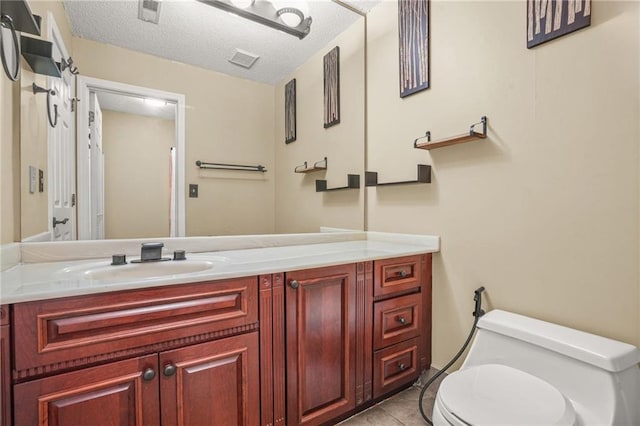 539 Mcgill Park Ave NE, Atlanta, GA 30312 - bathroom featuring toilet, vanity, tile patterned flooring, and a textured ceiling