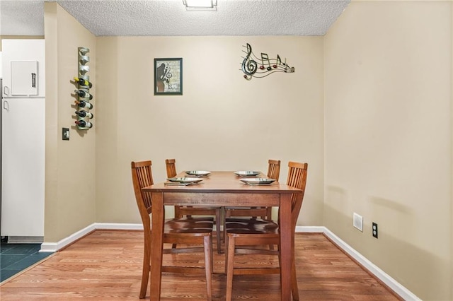 539 Mcgill Park Ave NE, Atlanta, GA 30312 - dining room with a textured ceiling, baseboards, and wood finished floors