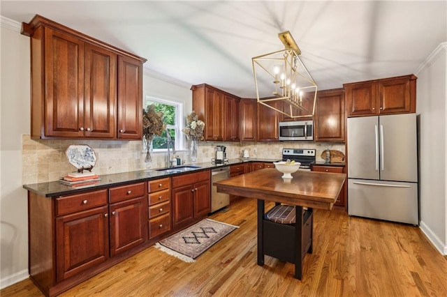 1600 Belle Isle Cir NE, Atlanta, GA 30329 - kitchen with stainless steel appliances, ornamental molding, light wood-style floors, decorative backsplash, and decorative light fixtures