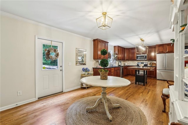 1600 Belle Isle Cir NE, Atlanta, GA 30329 - kitchen featuring appliances with stainless steel finishes, a kitchen island, dark countertops, ornamental molding, and tasteful backsplash