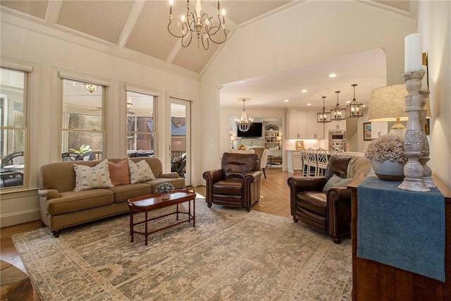 living room featuring a notable chandelier, wood-type flooring, and high vaulted ceiling