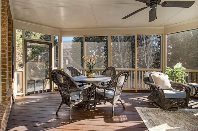 sunroom / solarium featuring ceiling fan