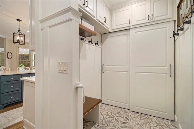 mudroom with a chandelier