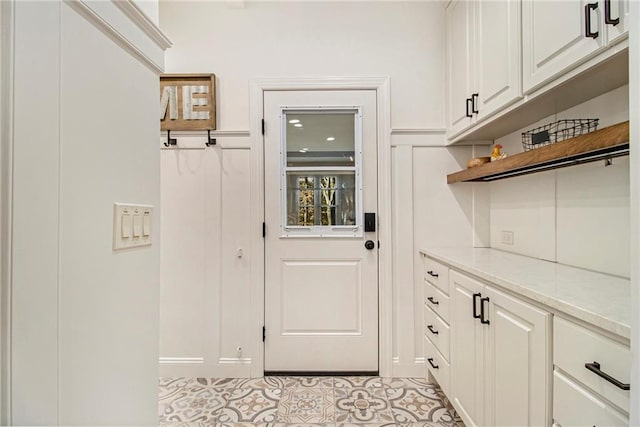 doorway to outside with light tile patterned flooring