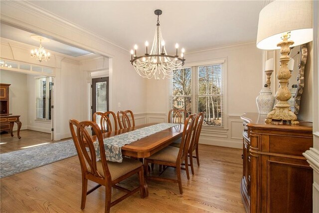 home office with hardwood / wood-style floors, an inviting chandelier, french doors, and ornamental molding